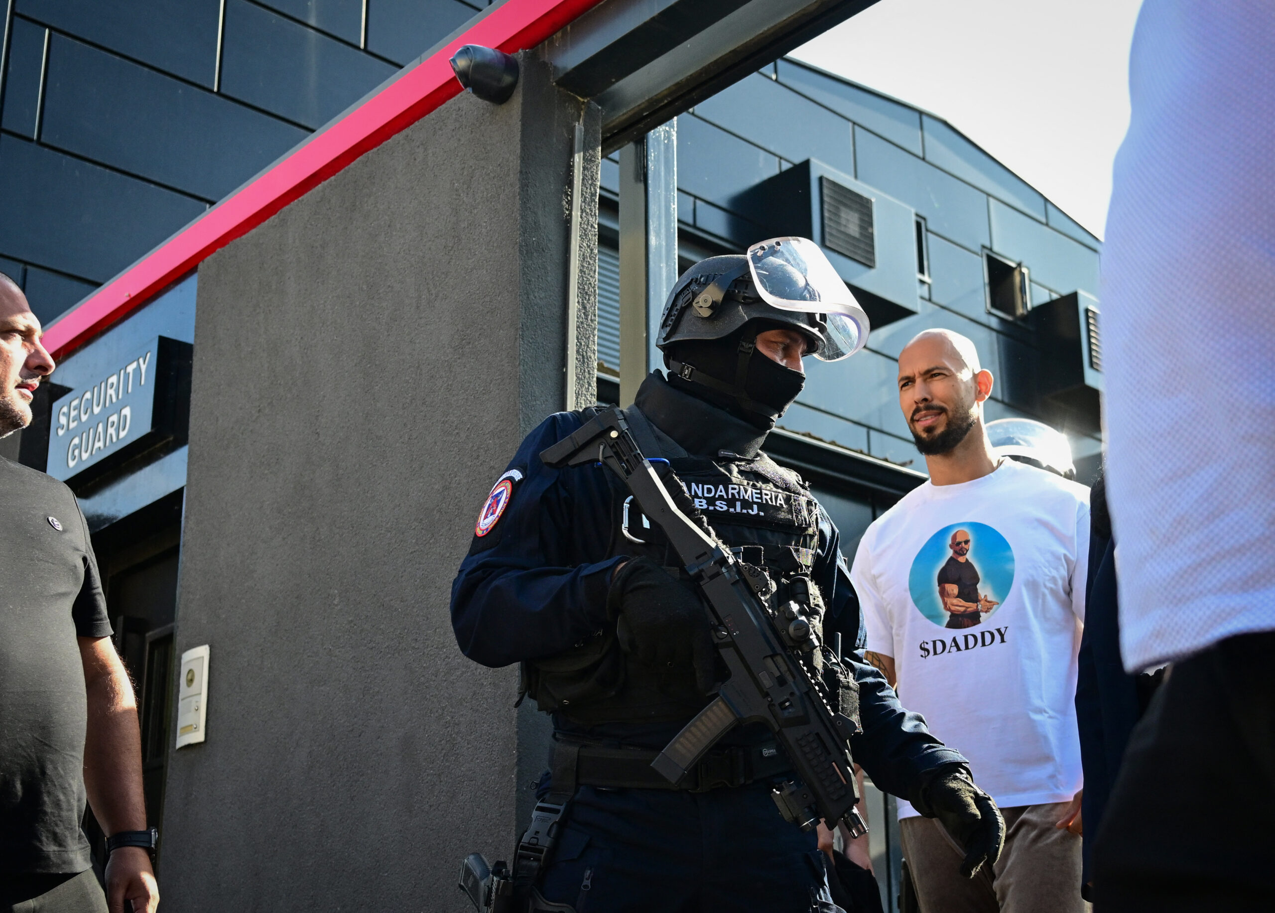 Andrew Tate during the raid, wearing a $DADDY shirt.