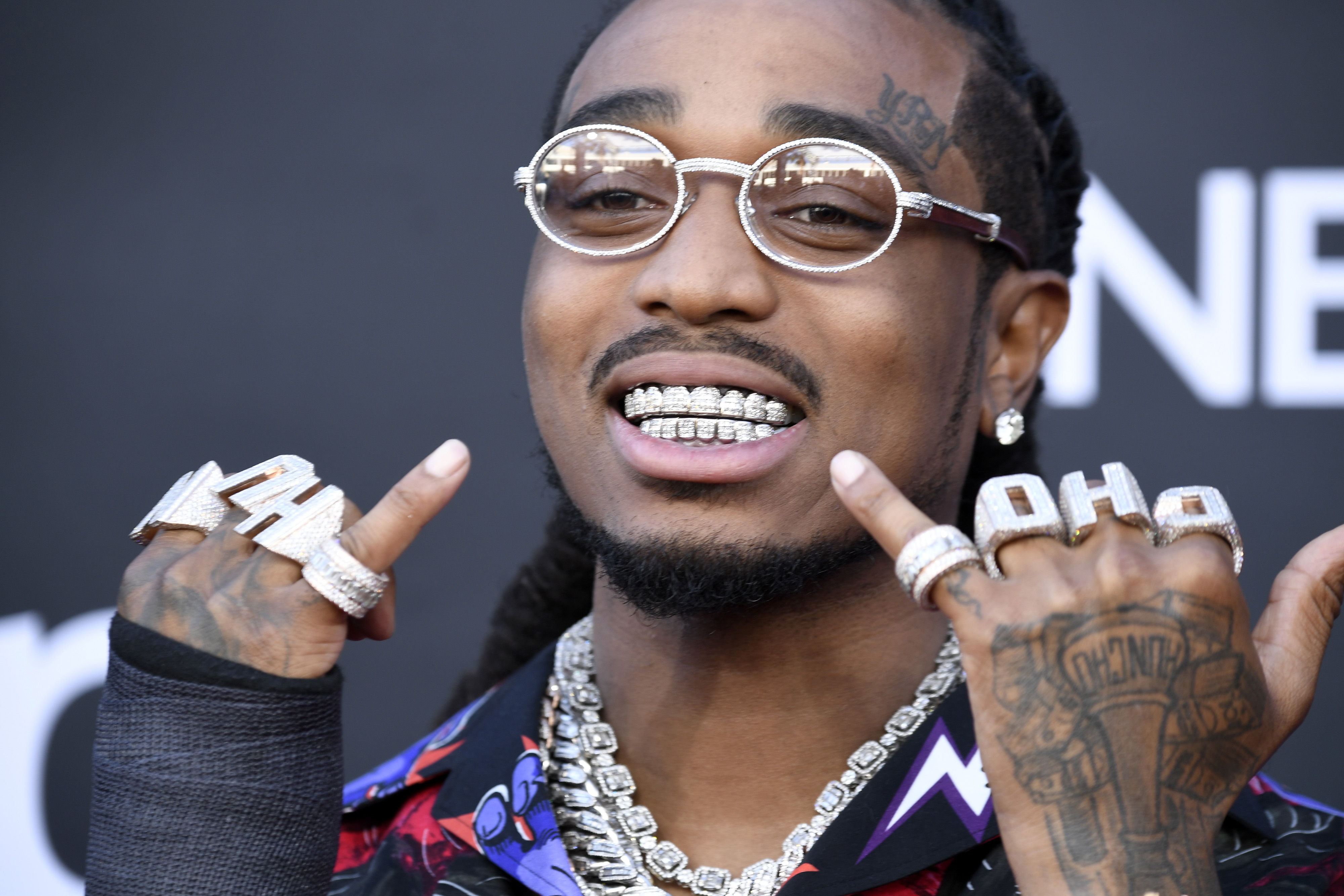 A detailed look at Quavo's grillz: emerald diamonds intricately cut ...