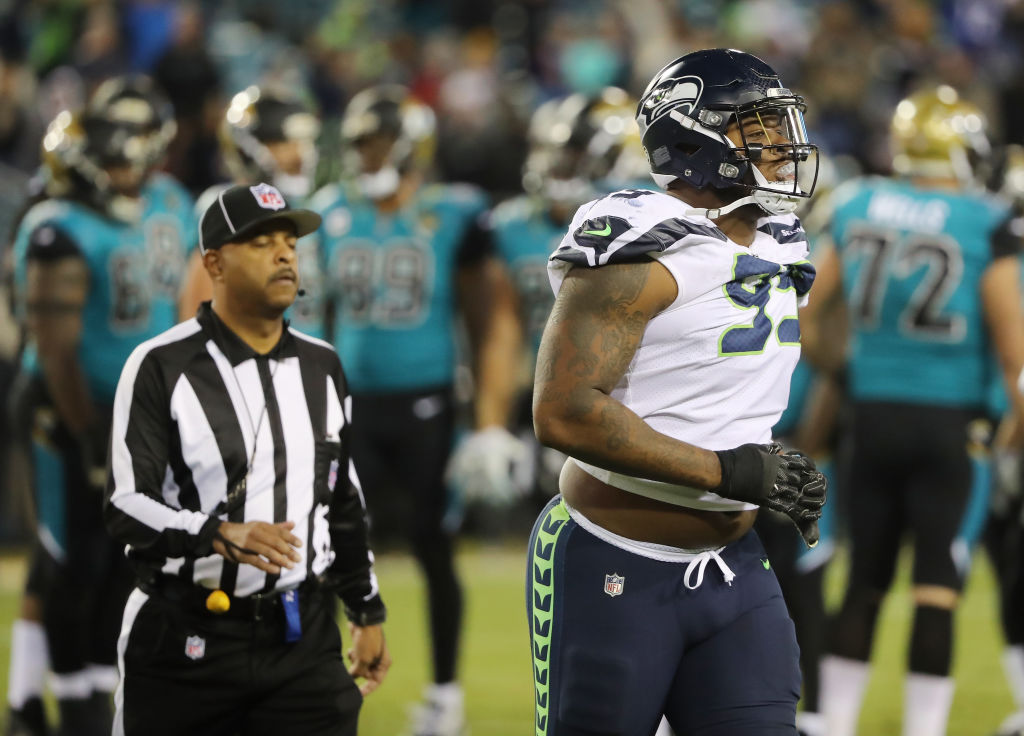 Seahawks' Quinton Jefferson tries to climb into stands to confront fans