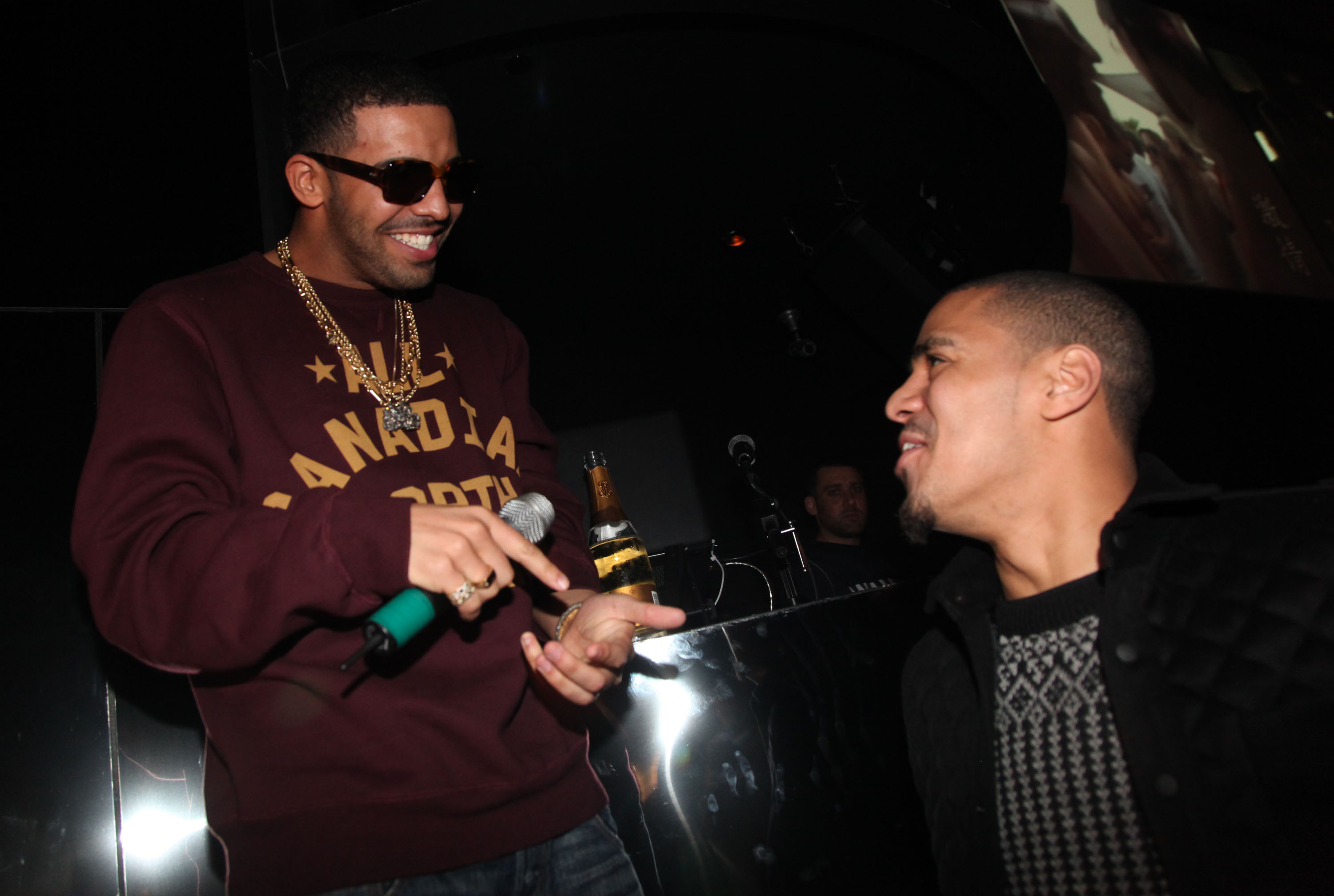 Drake cheers on friend J. Cole and wears his jersey during a basketball  game in Toronto on Saturday