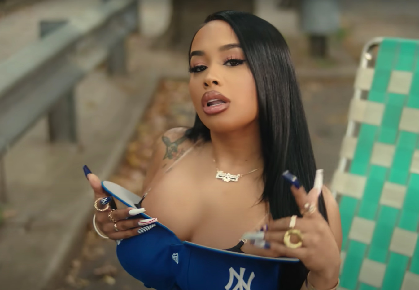 DreamDoll Wears A Bra Made Out Of Fitted Caps In New Music Video