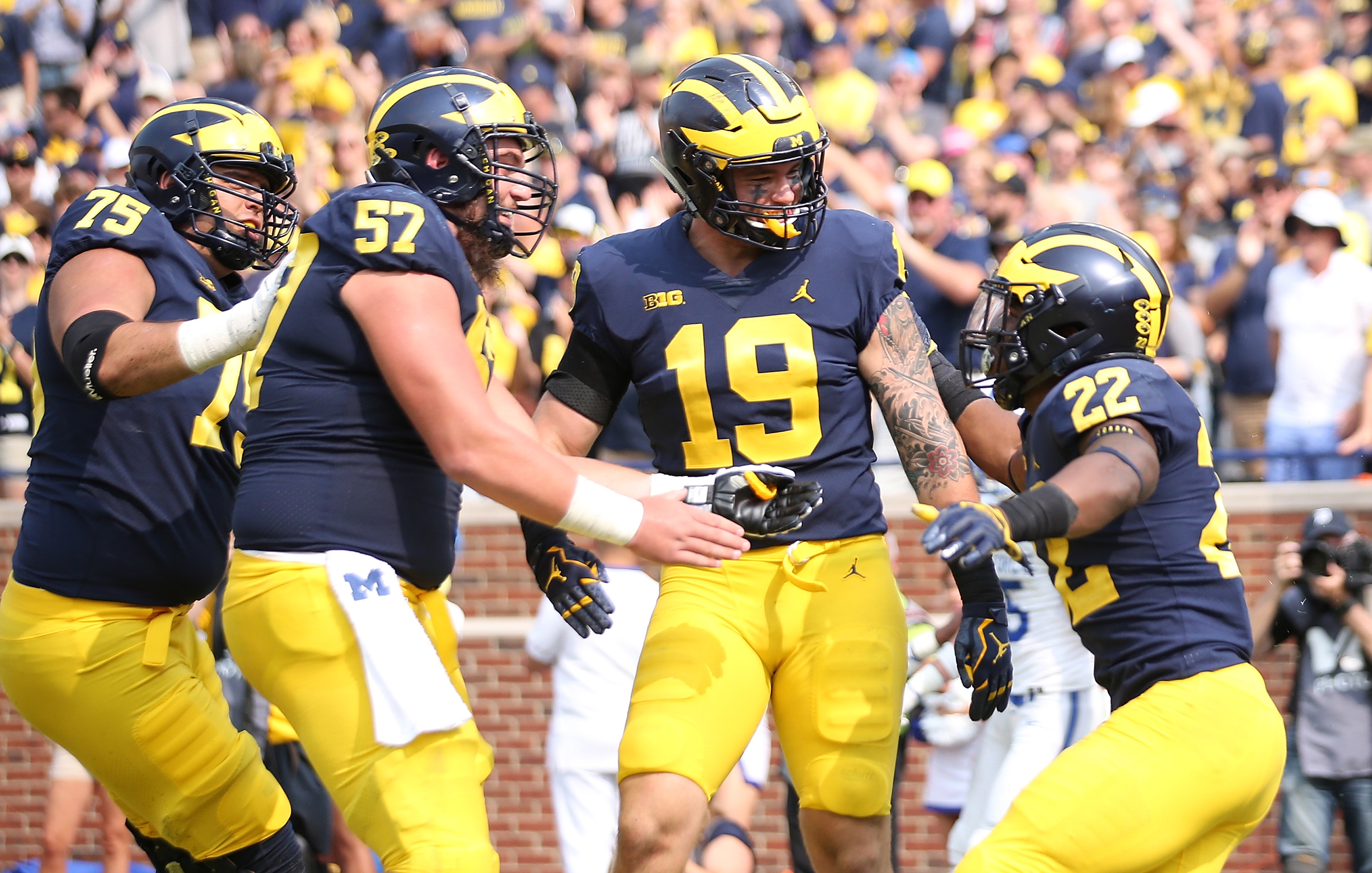 Michigan Football Players Lock Arms in Circle During National Anthem